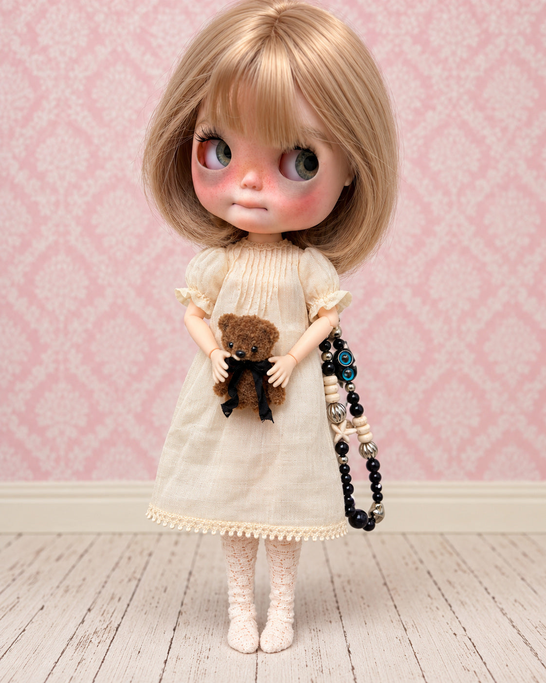 AI-edited presentation image of Nell in a pink miniature studio. Based on real product references; scene furniture and props are not included.